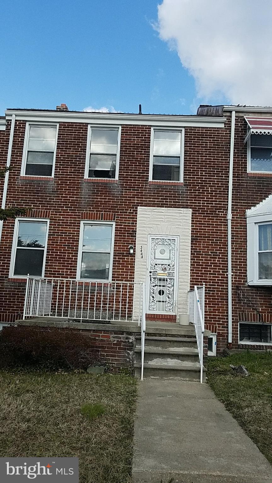 view of property featuring brick siding