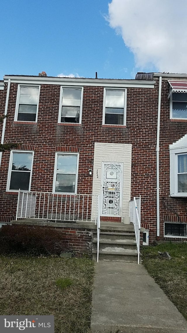view of property featuring brick siding