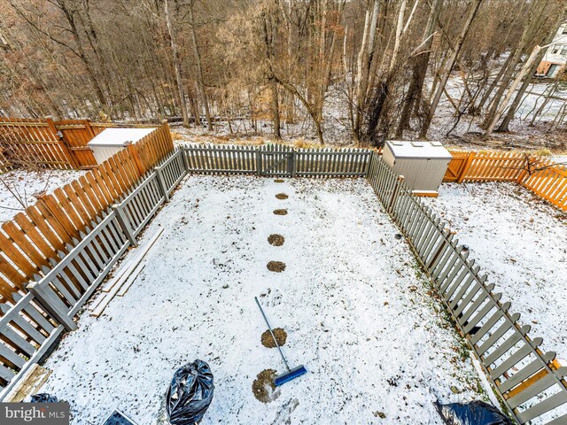 snowy yard with a storage unit