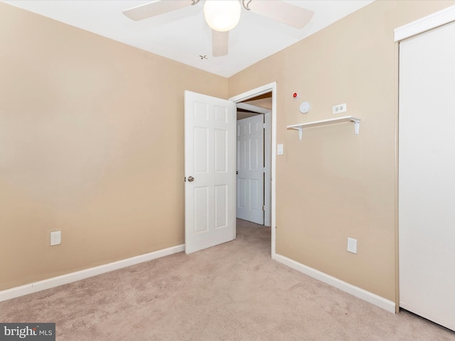 empty room with ceiling fan and light colored carpet