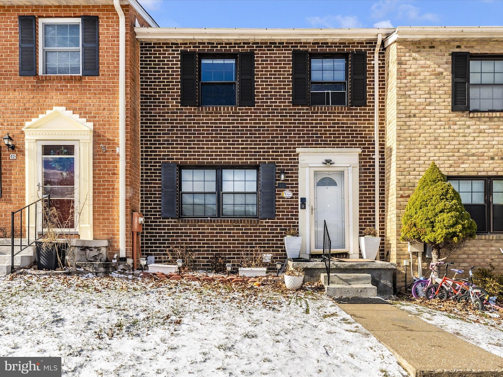 view of property featuring brick siding