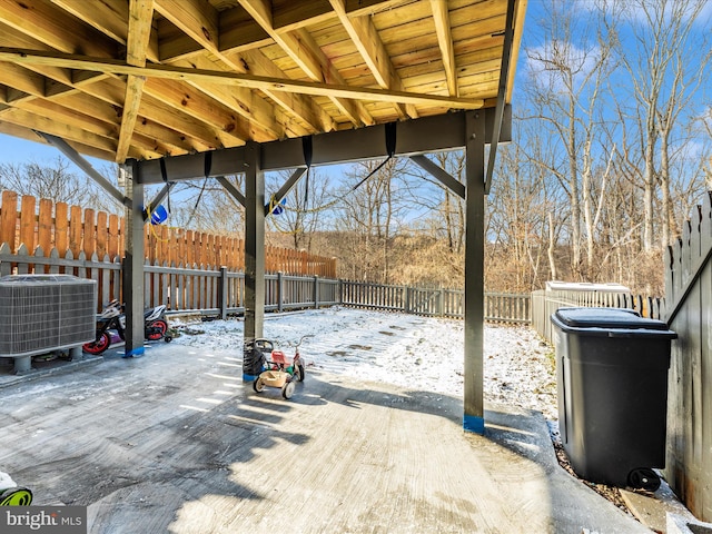 snow covered patio featuring central air condition unit