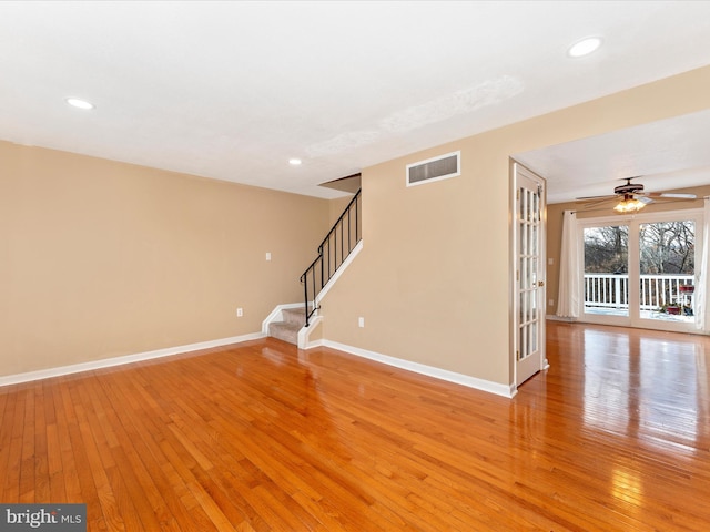 empty room featuring french doors, light wood-type flooring, and ceiling fan