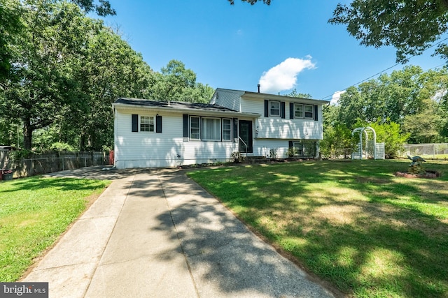 tri-level home with a front lawn