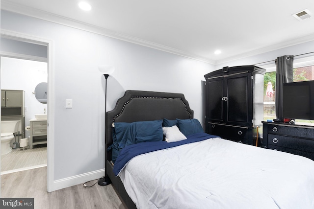 bedroom featuring light hardwood / wood-style flooring and ornamental molding