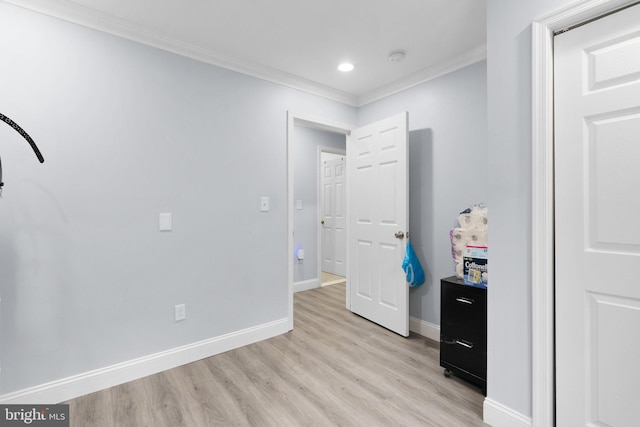 unfurnished bedroom featuring light wood-type flooring and crown molding