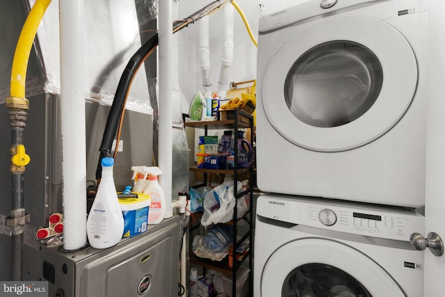 washroom featuring stacked washing maching and dryer