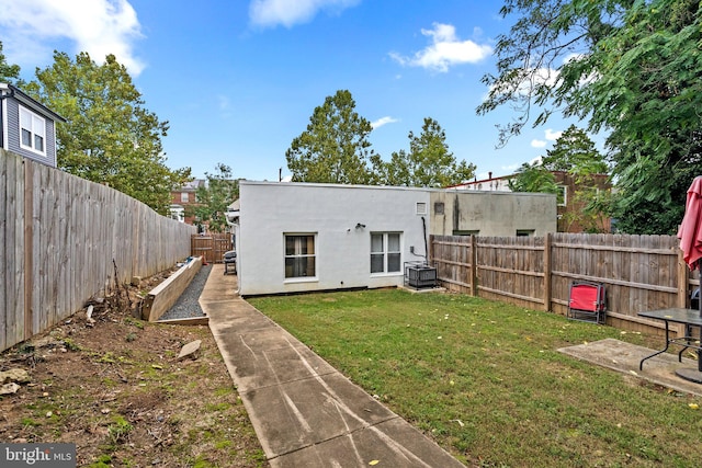 rear view of house with a yard