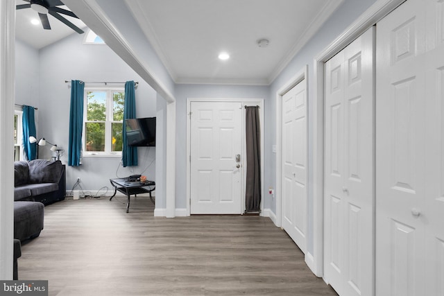 foyer with ornamental molding, hardwood / wood-style floors, and ceiling fan