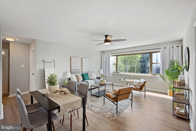 living room with light wood-type flooring and ceiling fan