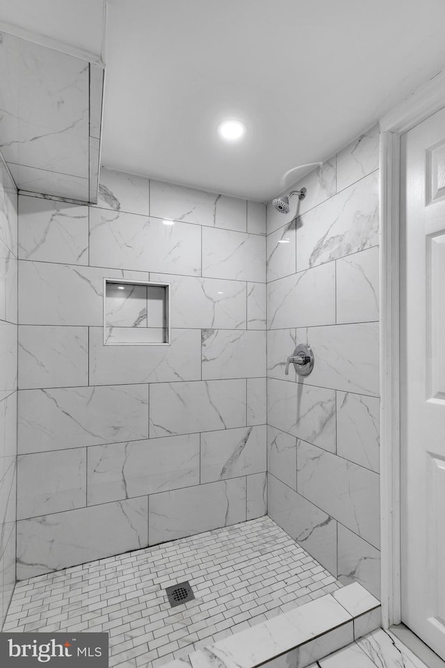 bathroom with a tile shower