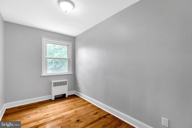 unfurnished room with radiator and light hardwood / wood-style floors