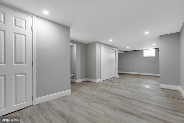 basement with light hardwood / wood-style floors