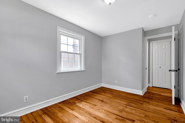 unfurnished room featuring hardwood / wood-style flooring