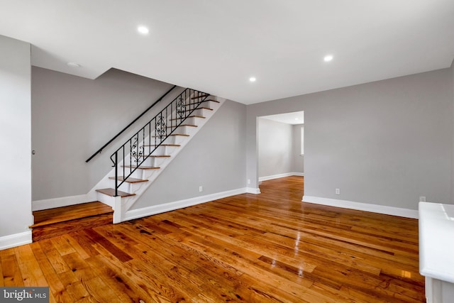 unfurnished living room featuring wood-type flooring