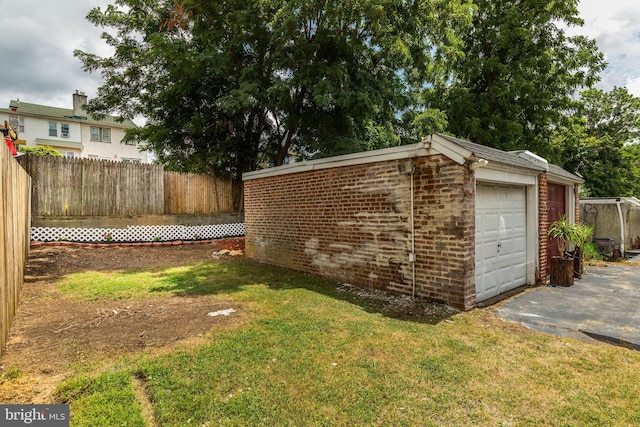 exterior space with a garage and a lawn