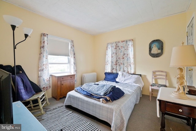 carpeted bedroom featuring radiator