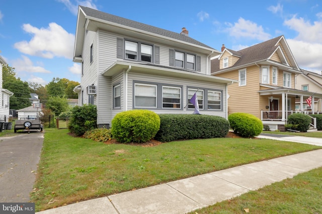 view of front facade featuring a front lawn and covered porch