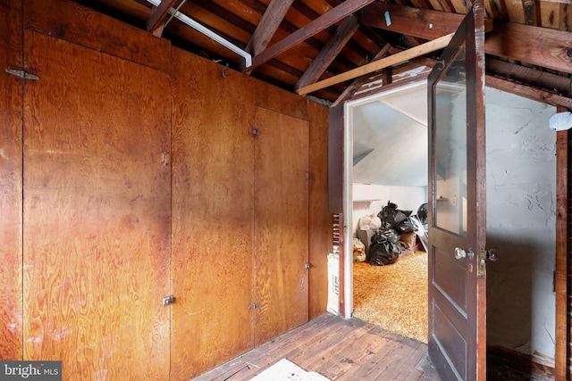 interior space with lofted ceiling and hardwood / wood-style floors