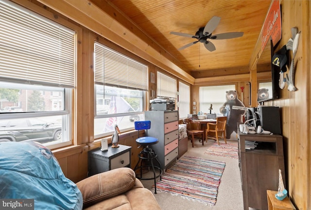 sunroom with ceiling fan, a wealth of natural light, and wooden ceiling