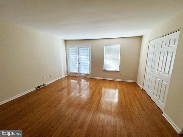 unfurnished bedroom with wood-type flooring