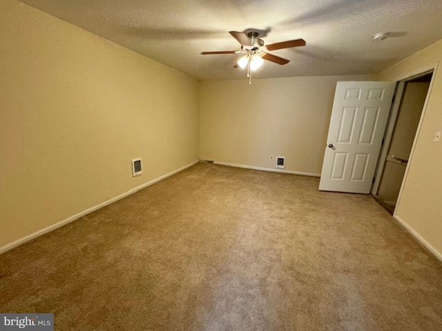 interior space with carpet floors, a textured ceiling, and ceiling fan