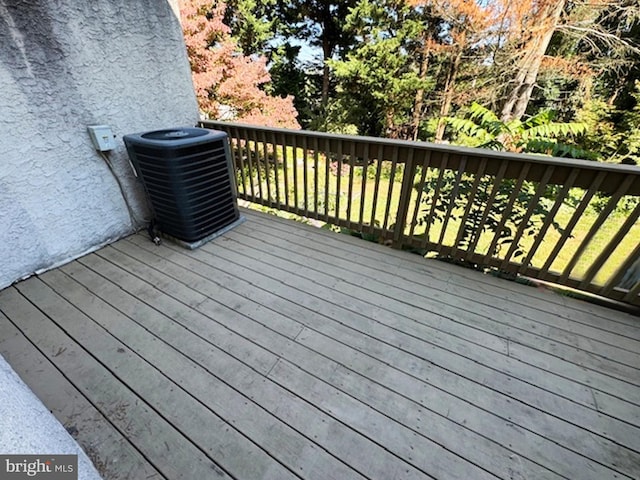 wooden deck featuring central AC unit