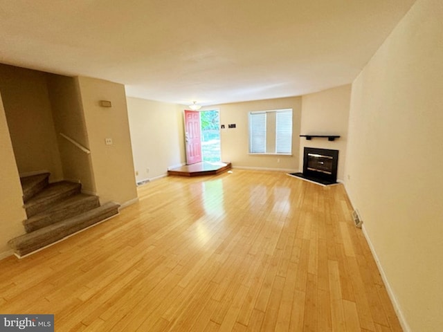 unfurnished living room with light wood-type flooring