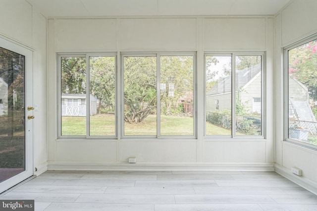 unfurnished sunroom featuring a healthy amount of sunlight