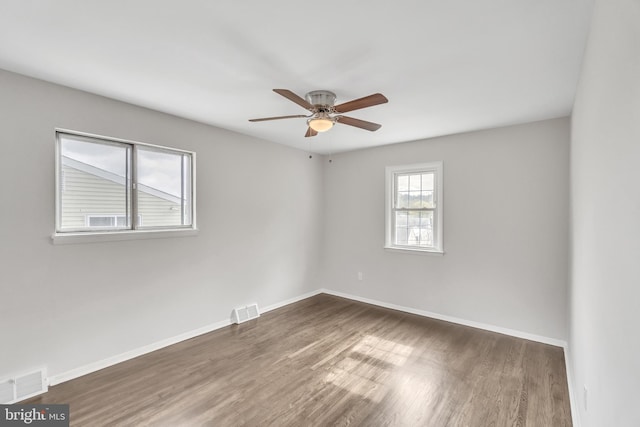 unfurnished room featuring ceiling fan and dark hardwood / wood-style flooring