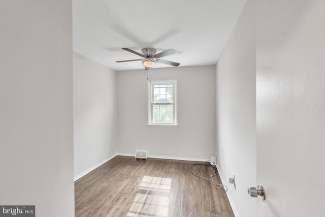 spare room with ceiling fan and hardwood / wood-style flooring