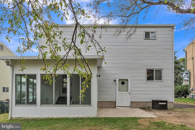 rear view of house featuring central air condition unit and a sunroom