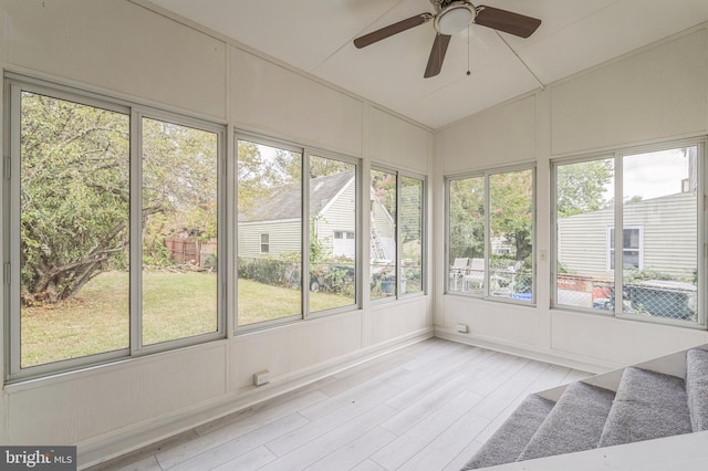 unfurnished sunroom featuring ceiling fan and vaulted ceiling