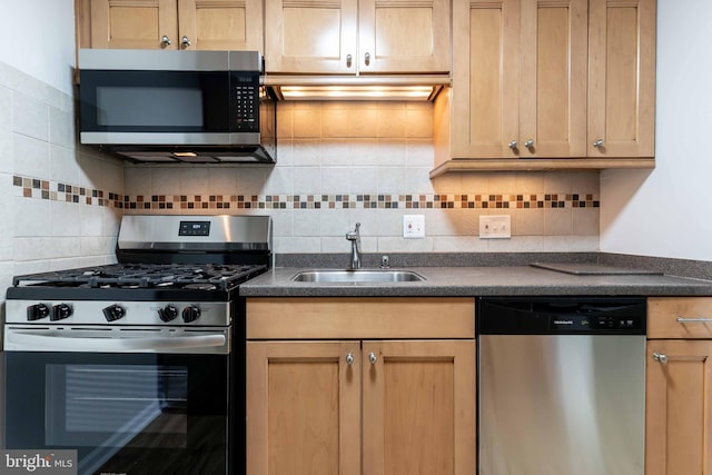 kitchen featuring stainless steel appliances, sink, and decorative backsplash