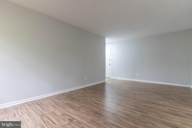 unfurnished room with wood-type flooring