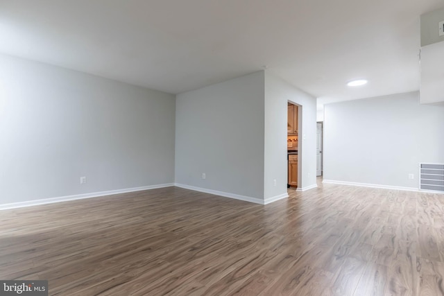 spare room with wood-type flooring