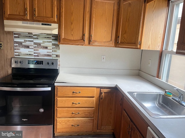 kitchen featuring ventilation hood, sink, tasteful backsplash, and stainless steel electric range