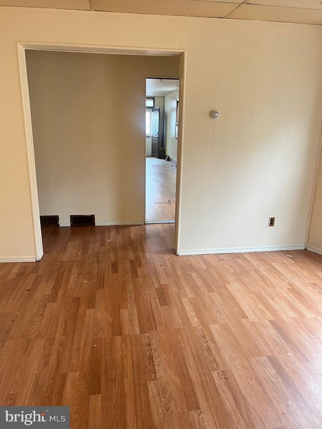 unfurnished room featuring hardwood / wood-style flooring