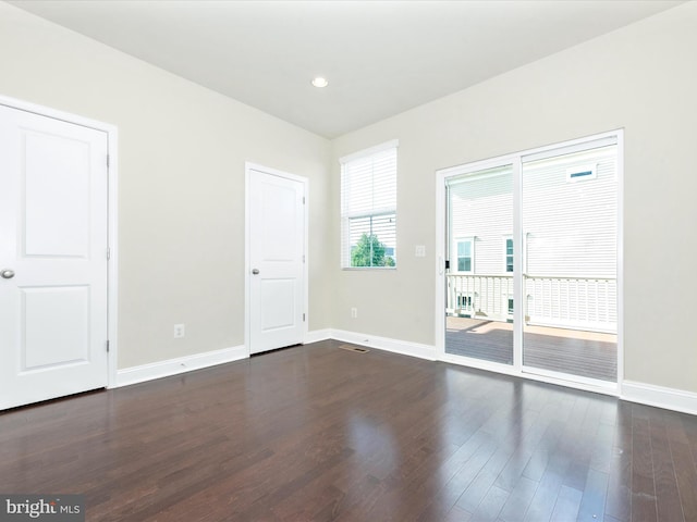 unfurnished room featuring dark hardwood / wood-style flooring