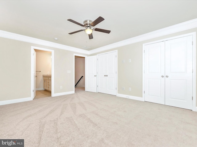 unfurnished bedroom featuring ceiling fan, ornamental molding, light carpet, and ensuite bathroom