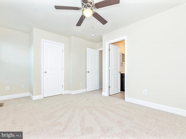 unfurnished bedroom with ceiling fan and light carpet