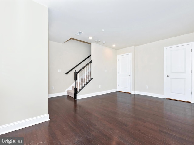 spare room with dark wood-type flooring