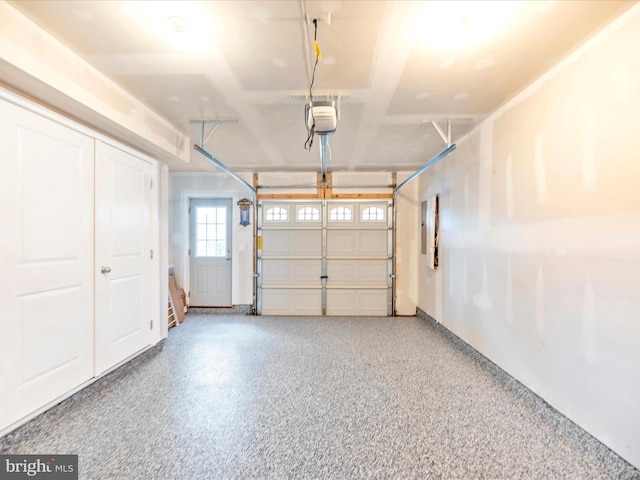 garage featuring electric panel and a garage door opener