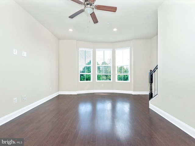 unfurnished living room with ceiling fan and dark hardwood / wood-style floors