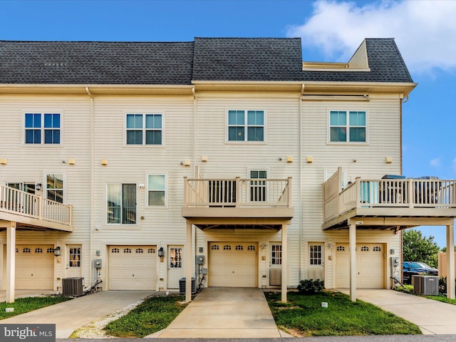 exterior space featuring a balcony, a garage, and central air condition unit