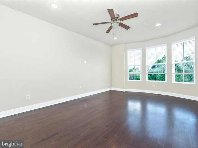 unfurnished room featuring ceiling fan and dark hardwood / wood-style flooring