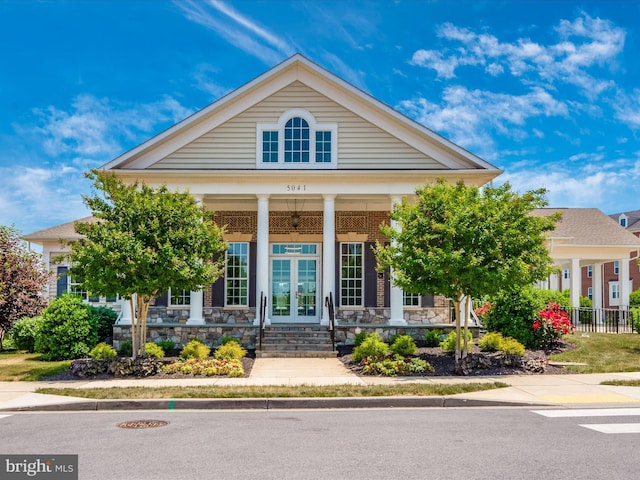 neoclassical / greek revival house featuring french doors and a porch