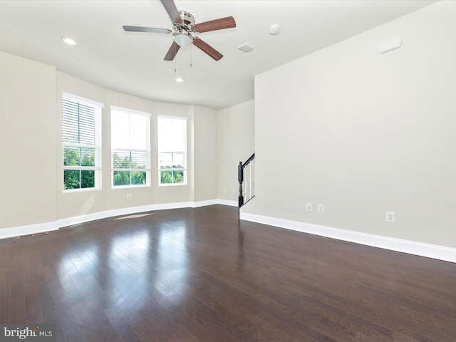 spare room with ceiling fan and dark hardwood / wood-style flooring