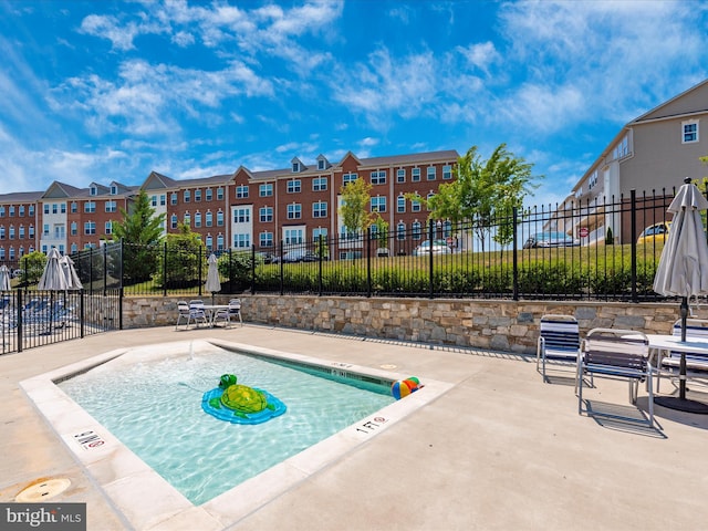 view of swimming pool featuring a patio area