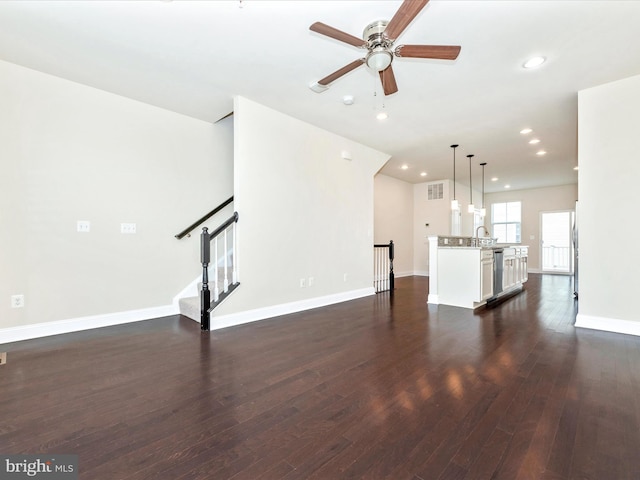 unfurnished living room with ceiling fan, sink, and dark hardwood / wood-style flooring